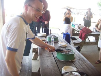 Shane and Dave cutting the cake at their wedding